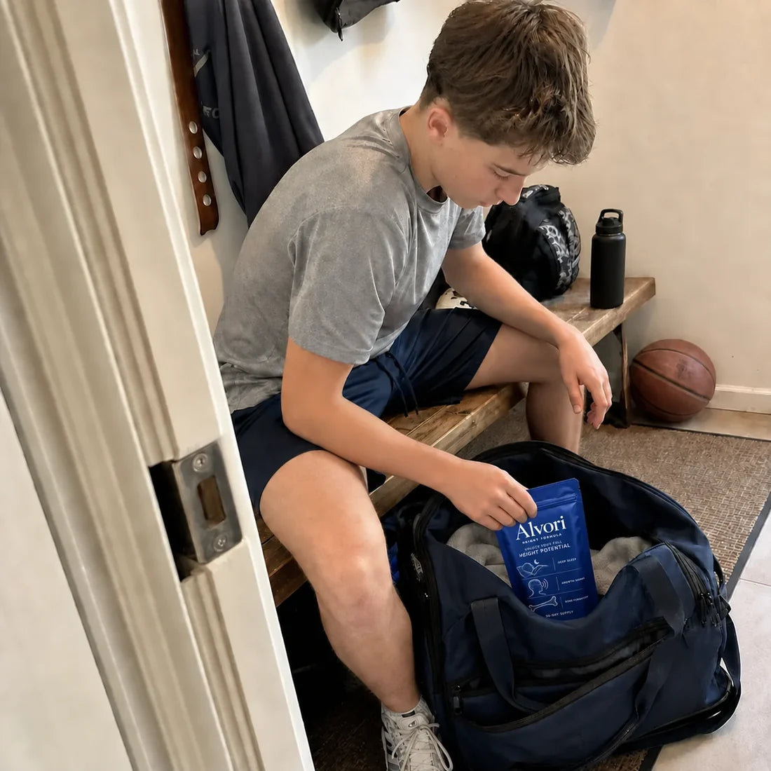 Teen packing Alvori in a sports bag